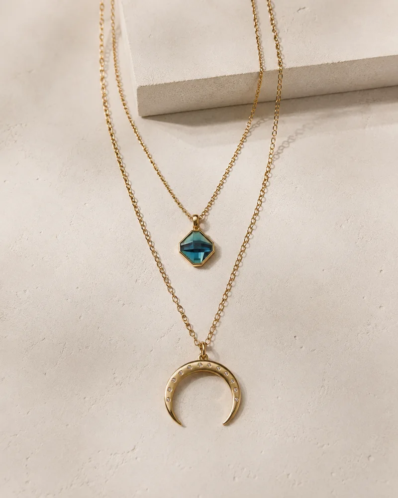 Gold pendant in warm editorial styling